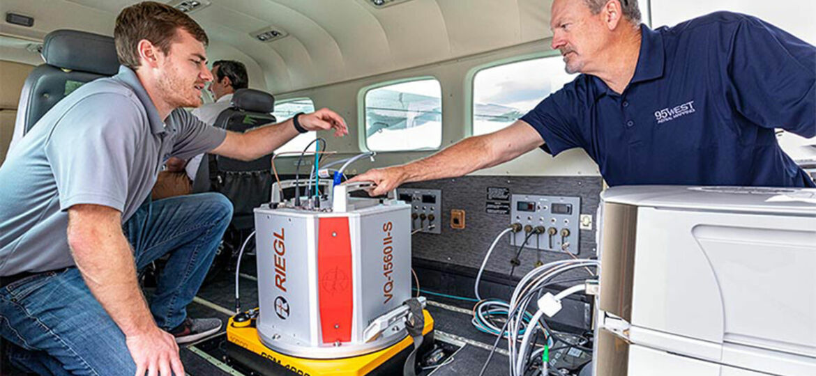 95West Pilot Andrew Werle (left) checks the RIEGL scanner with Aerial Services Manager Miles Strain (right) before takeoff.