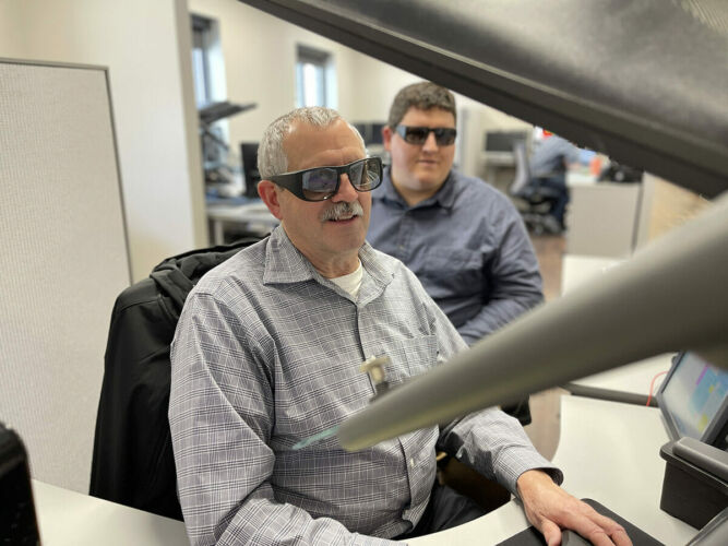 Two people with glasses viewing photogrammetry image. Three-dimensional data combined with aerial imagery