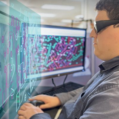 Person with glasses viewing photogrammetry image. Three-dimensional data combined with aerial imagery.