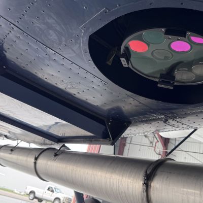 Photo of the bottom of 95West plane with aerial equipment and exhaust extension